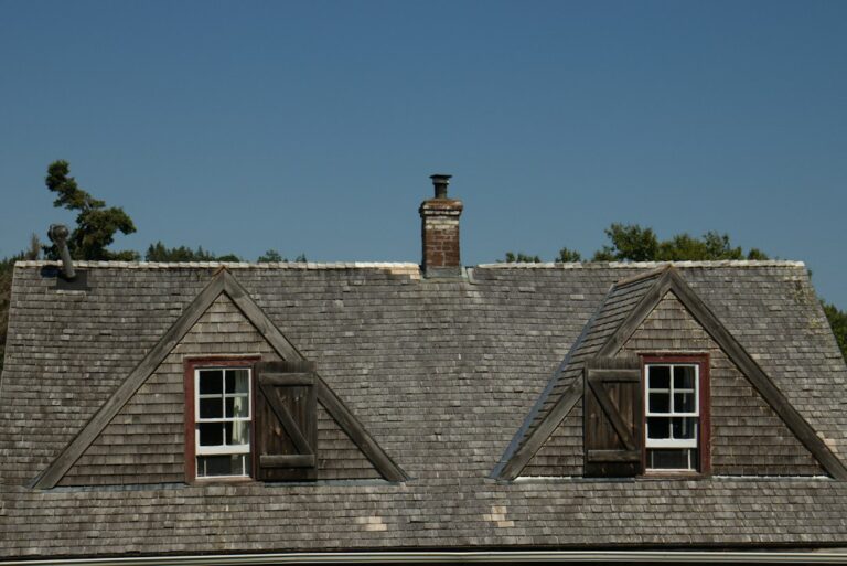 Attic roof boards with visible condensation, rusty nails, damp insulation, and a ventilation opening.
